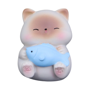 Cute white cat figurine holding a blue fish for office desk and car dashboard decor