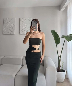 Detail of black bodycon maxi dress with waist cut-outs and golden metal rings