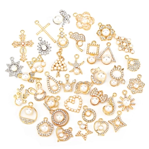 DIY jewelry pendants with gold alloy pearls and sparkling zircons on white background