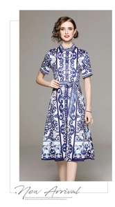 Detail of blue and white porcelain print midi dress with shirt collar and belt