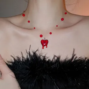 Artistic crystal beaded necklace with red heart pendant and fluid tassel design