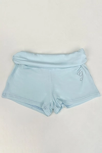 Detail of light blue mini shorts with fold-over waist and rhinestone letter G