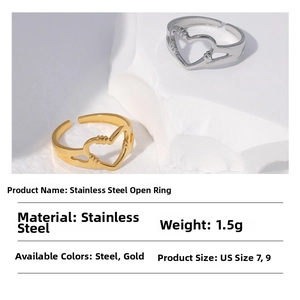 Detail view of hollow heart rings in gold and silver steel with size and weight info