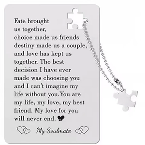 Macro view of stainless steel wallet card and matching puzzle piece necklace set