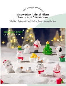 Miniature resin Christmas animals including puppies and snowmen playing in the snow