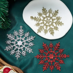 Glittery gold, silver and red Christmas snowflake ornaments for holiday tree decoration