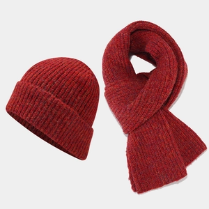 Close-up of thick ribbed knit hat and scarf set in deep red heathered winter blend