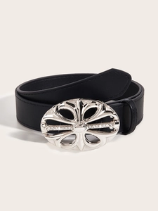 Macro detail of black leather belt featuring an oval cutout silver buckle with rhinestones