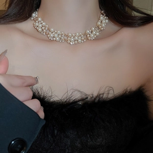 Detailed view of layered pearl and rhinestone necklace set in elegant gold finish