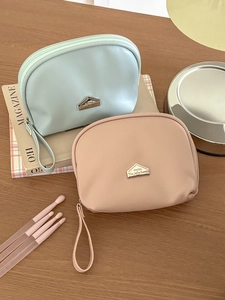 Mini semi-circle waterproof cosmetic bags in mint green and pink with wrist straps