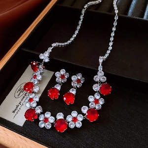 Exquisite red zircon flower necklace and earrings set displayed in a black velvet jewelry box