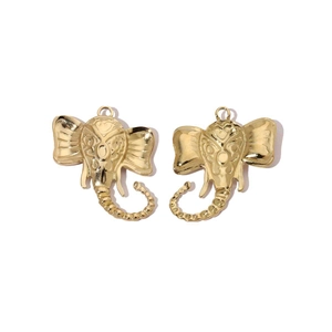 Macro shot of two polished golden elephant head pendants made of durable stainless steel