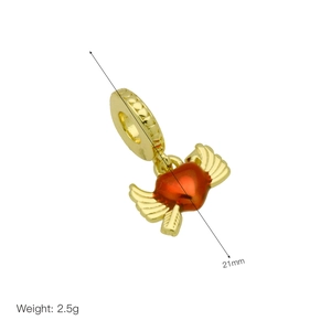 Macro view of a gold heart charm with wings and red enamel inlay for bracelets