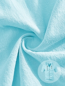 Detailed macro view of sky blue breathable linen texture on a men's hooded summer shirt