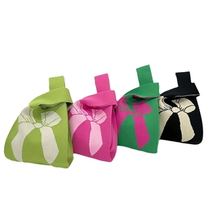 Knit wrist bag with bow pattern available in green, pink, and black colors
