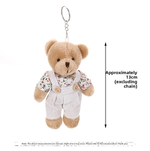 Detail of 13cm teddy bear plush keychain wearing floral shirt and white suspender pants