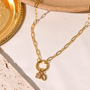 Detail of 18K gold-plated paperclip chain necklace with pink gemstone and oval pendant