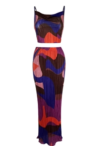 Detail shot of printed plissé fabric texture on women's two-piece crop top and maxi skirt