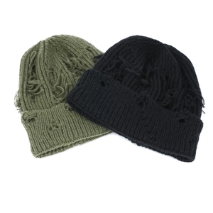 Close-up of distressed knit beanies showing detailed ripped textures and holes