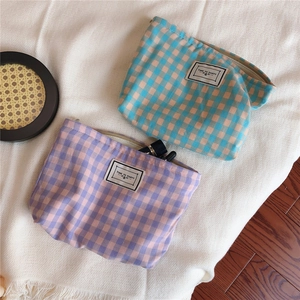 Detail view of colorful checkered cotton makeup bags with a TIME TO PARTY fabric label