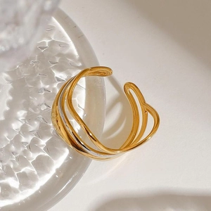 Polished 18K gold and silver layered water wave ring on glass edge minimalist style