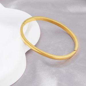 Minimalist gold-plated stainless steel oval bangle with a high-polished mirror finish