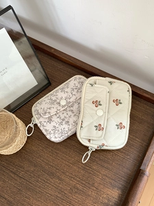 Detail of quilted cotton linen storage pouches with plant patterns and zipper closures