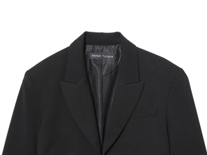 Detail of black cropped blazer neckline with shoulder pads and size S brand label