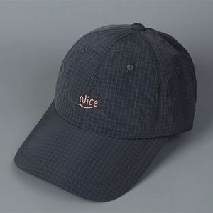 Close-up of Nice embroidery on lightweight ripstop plaid fabric of a grey baseball cap
