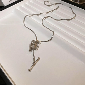 Detail of silver snake chain necklace with a unique multi-layer spiral geometric pendant