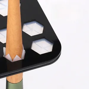 Detail of hexagonal silicone buckles and acrylic panel for secure makeup brush storage