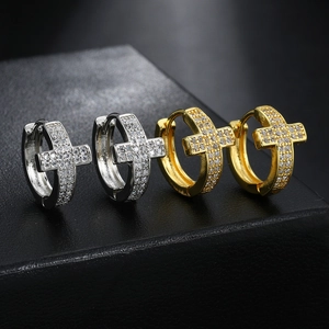 Iced out cross hoop earrings with gold and silver finishes in micro pave zircon style