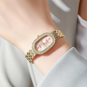 Montre à quartz dorée élégante pour femme avec lunette en cristal et cadran rose