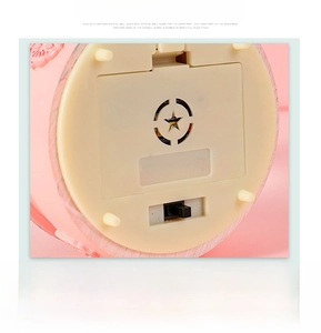 Detail of crystal ball music box base with battery compartment and power switch