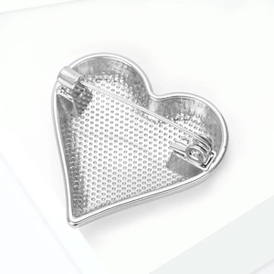 Detailed back view of silver alloy heart brooch showing textured metal and secure pin