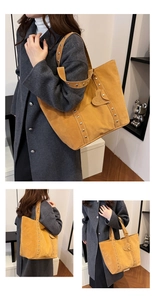 Detail of yellow suede tote bag with metallic studs and heart decoration on the shoulder strap