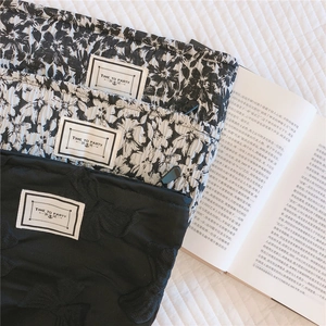 Close-up of bow jacquard and floral cosmetic bags with Time to Party labels