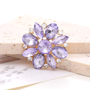 Elegant purple crystal flower accessory with golden base and white rhinestones