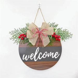 Christmas round wooden welcome door sign with faux pine, red berries and burlap bow decoration