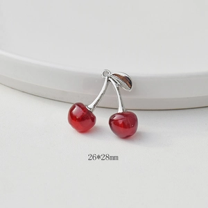 Detailed view of 26x28mm cherry pendant with red resin and silver metal leaf for DIY jewelry