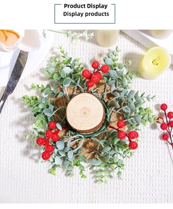 Top view of a Christmas candle ring with artificial green leaves and vibrant red berries