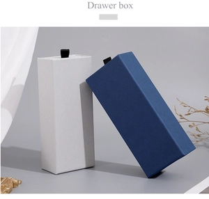 Detailed view of white and blue textured cardboard drawer boxes for gift packaging