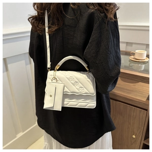 White textured faux leather handbag with floral embossing and matching mini coin purse detail