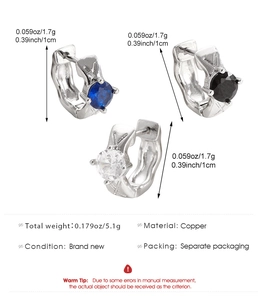 Detailed view of silver hoop earrings with blue black and white zircon stones