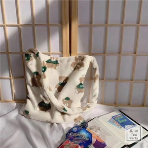 Detail of plush tote bag with brown cartoon bear prints and LOVED letter embroidery
