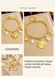 Detailed close-up of gold chain bracelet with pearl, heart, and sunflower charms