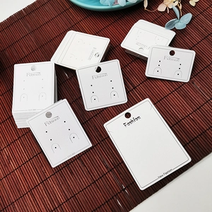 White cardboard jewelry display cards with Fashion and S925 print on bamboo mat