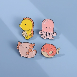Cartoon marine animal enamel pin set including seahorse and pufferfish on blue background