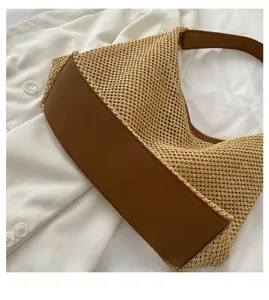 Detailed close-up of the woven straw tote with reinforced brown faux leather base detail