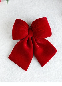 Detail of a large red velvet decorative bow with soft texture for festive ornaments